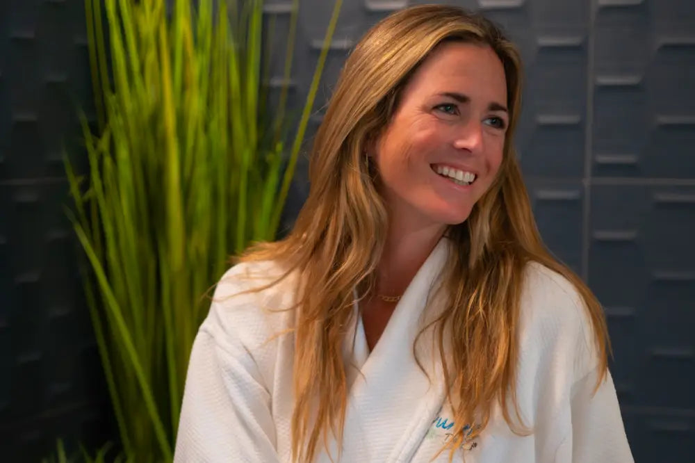 robed woman sipping champagne in spa room